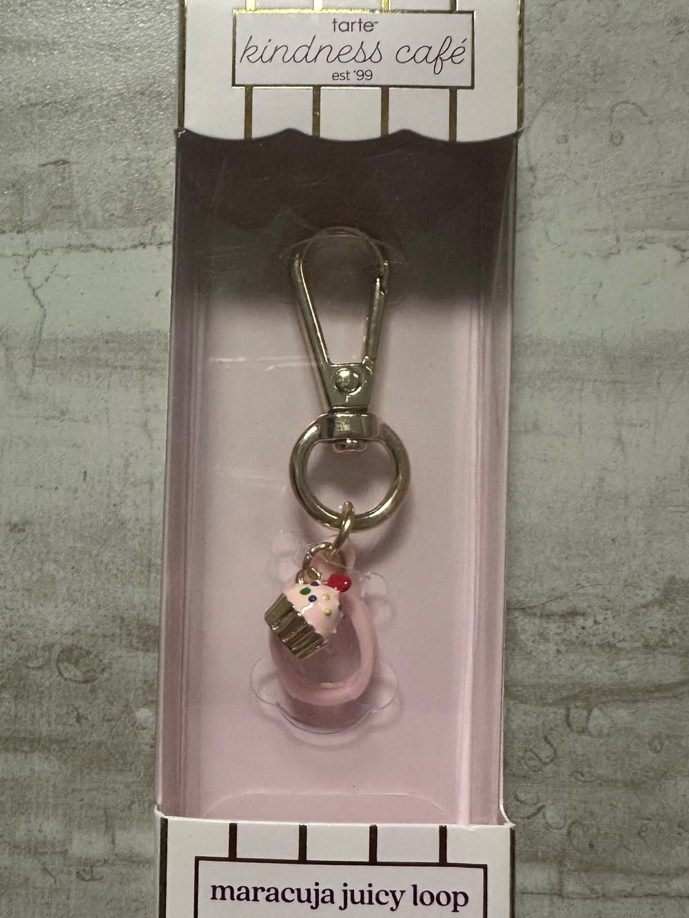 tarte maracuja juicy loop for juicy lip -gold hardware and cupcake charm